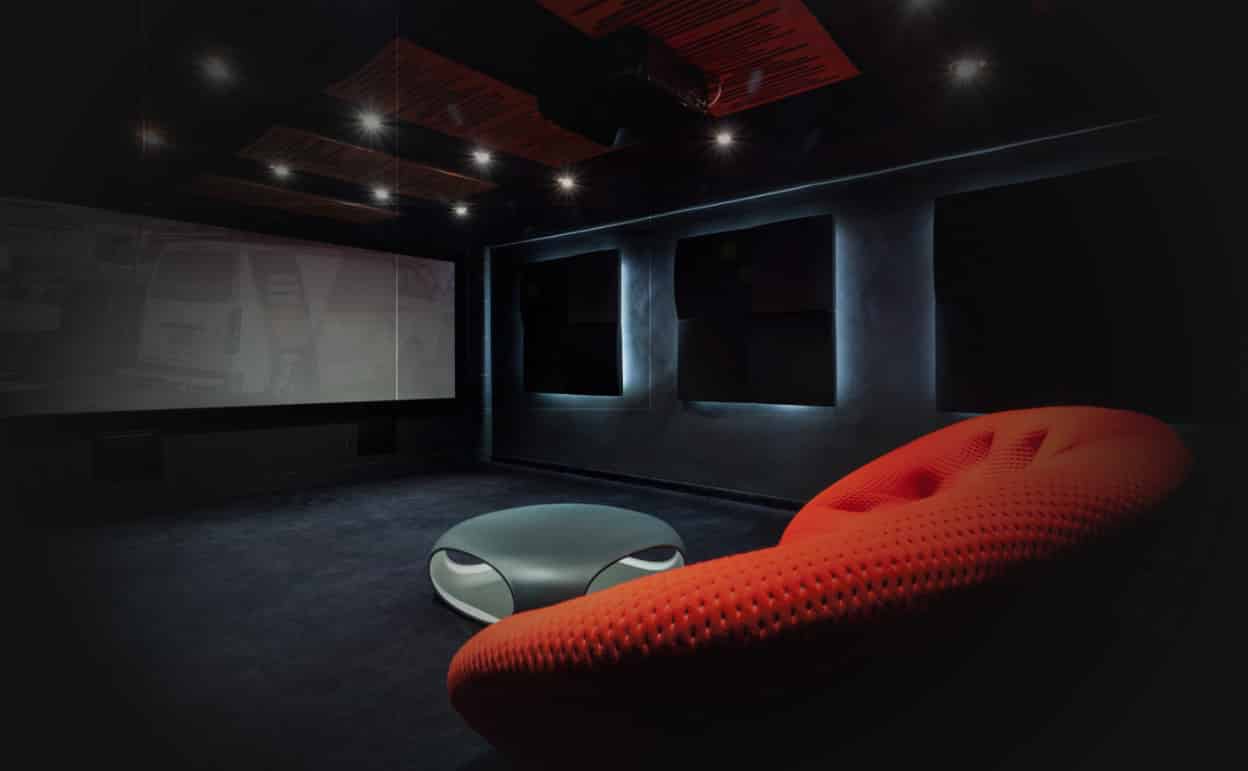 Home theatre with overhead projector and surround speakers.